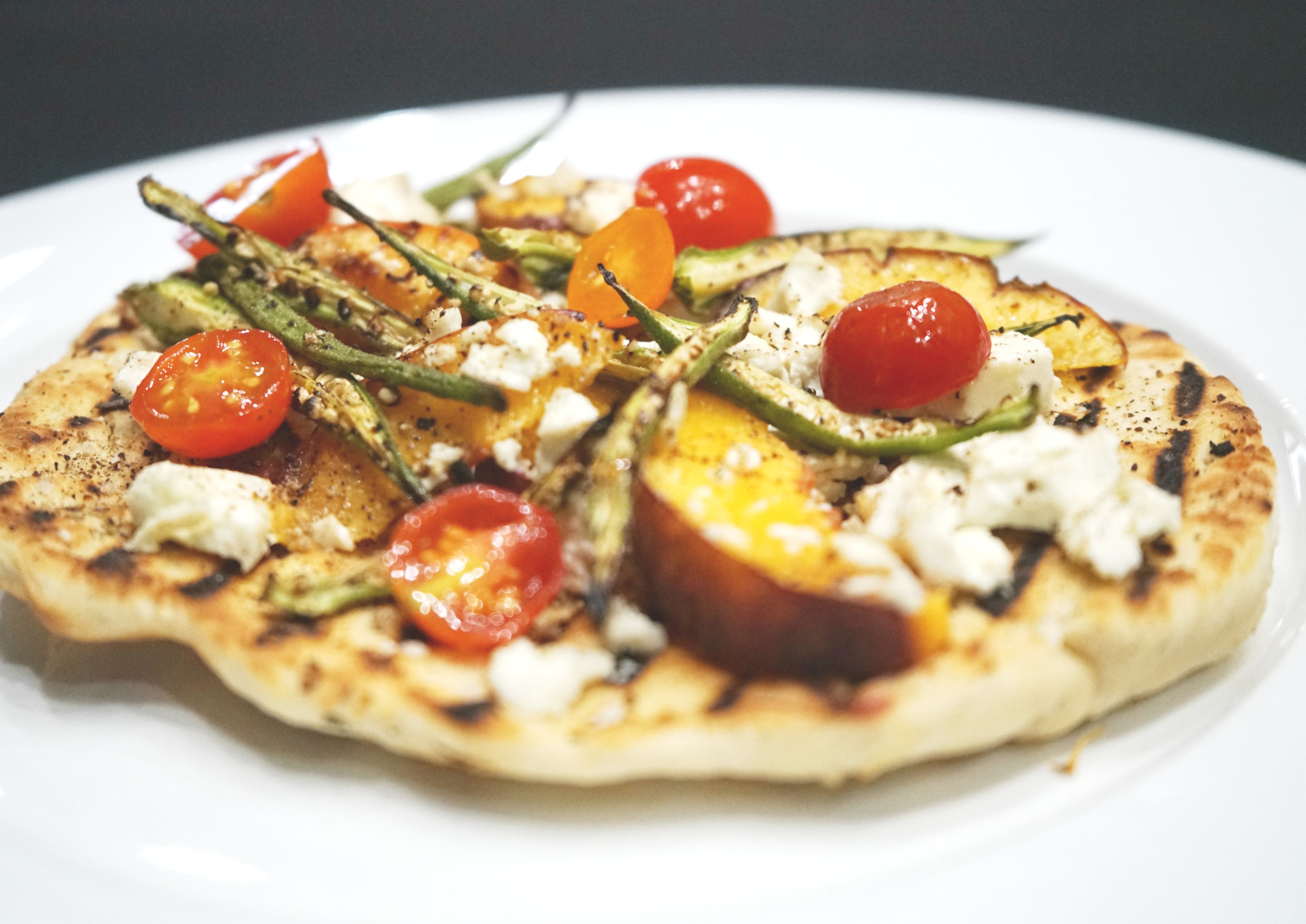 Wood Grilled Flat Bread with Charred Okra, Peaches, Cherry Tomatoes & Goat Cheese