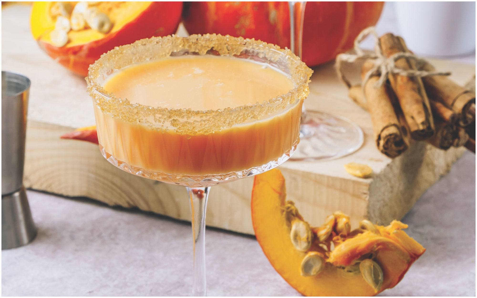 Pumpkin Spice Martini garnished with a cinnamon-sugar rim in a cocktail glass.